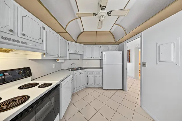 a kitchen with a white cabinets and white appliances
