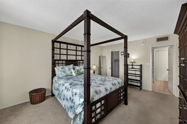 a bed room with a bed and a chair