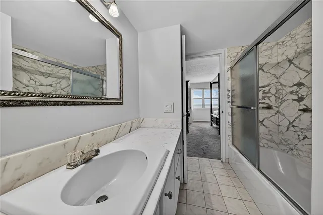 a bathroom with a tub sink and shower