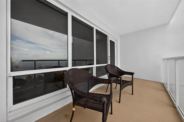 a balcony with table and chairs