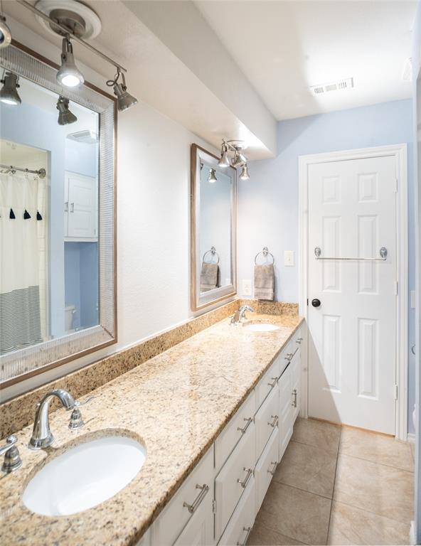 1451 Meandro Ria Lane Fairview, TX 75069 - Photo 30 of 38 a spacious bathroom with a granite countertop sink and a mirror