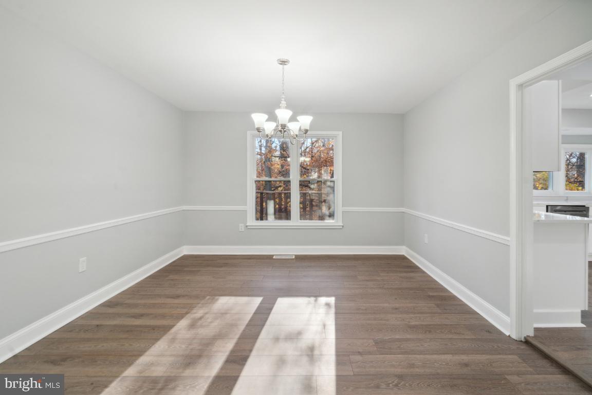 517 Holly Road Fort Washington, MD 20744 - Photo 11 of 40 wooden floor in an empty room with a window