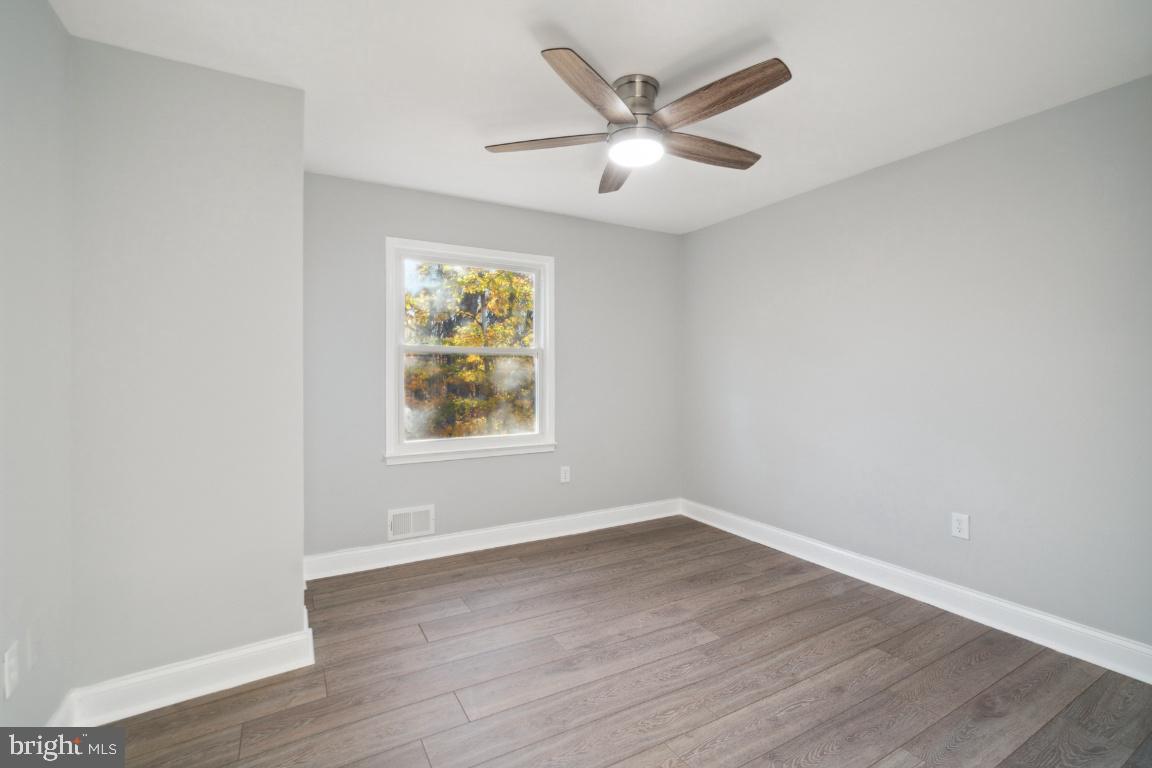 517 Holly Road Fort Washington, MD 20744 - Photo 16 of 40 an empty room with wooden floor and windows