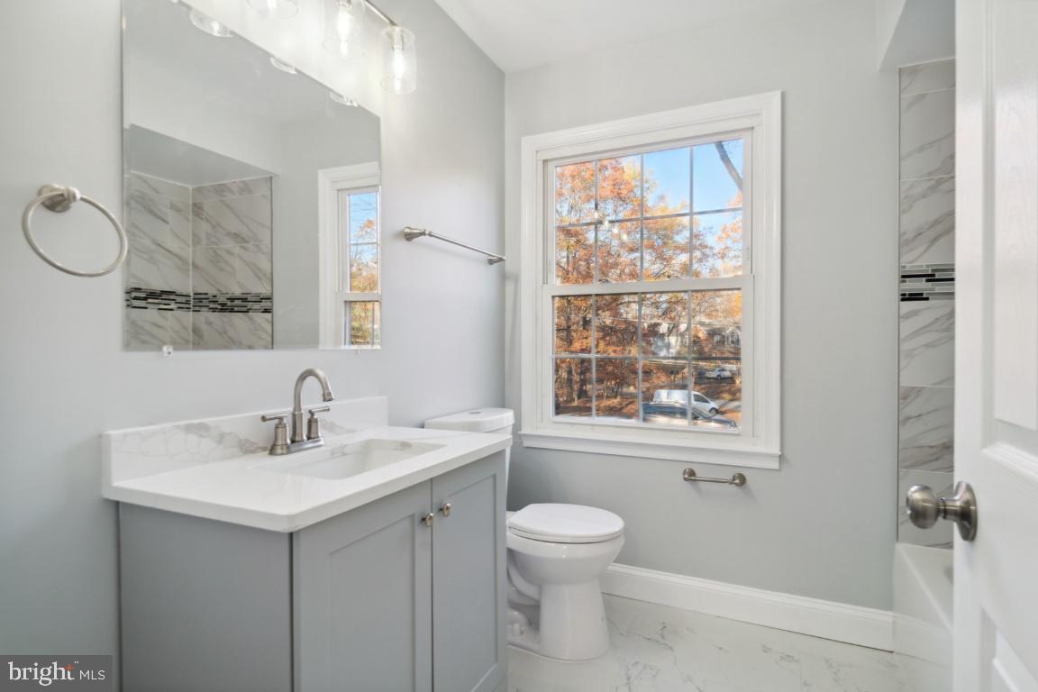517 Holly Road Fort Washington, MD 20744 - Photo 18 of 40 a bathroom with a toilet sink and mirror