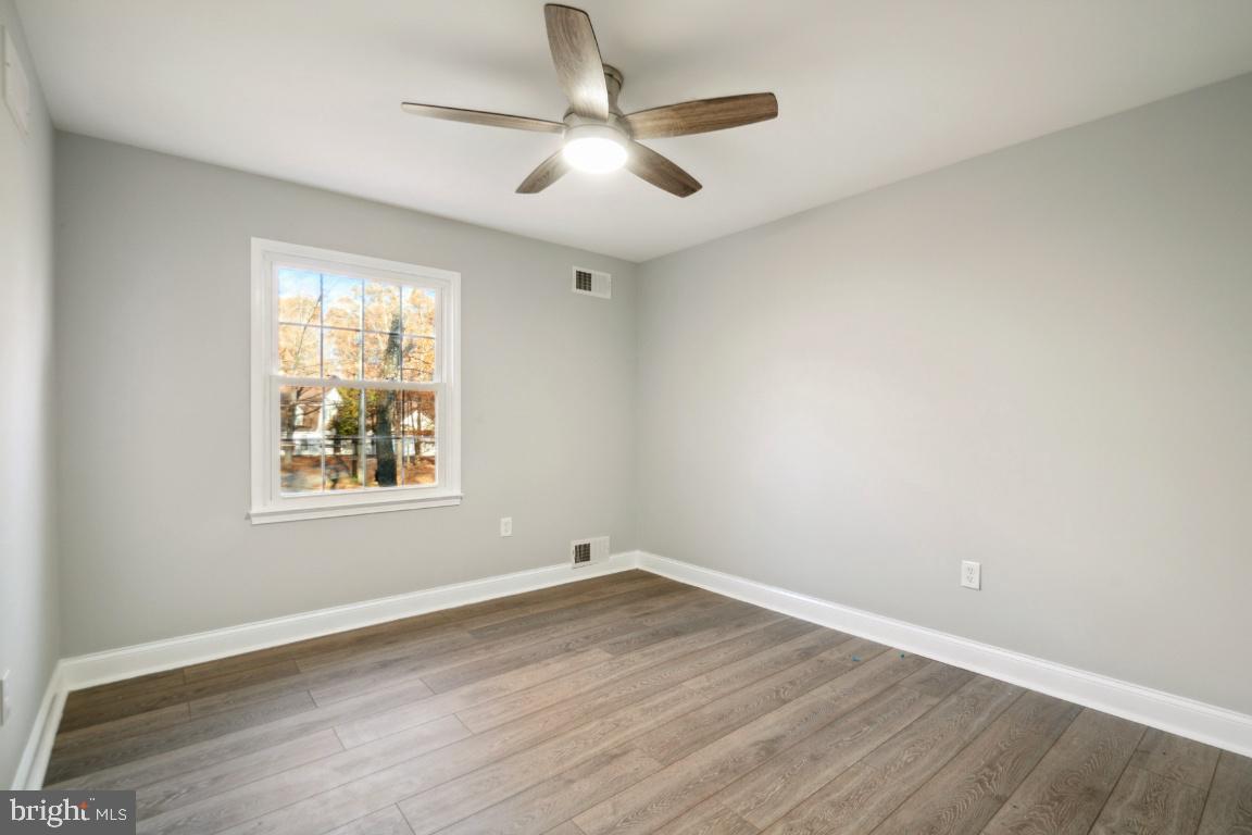 517 Holly Road Fort Washington, MD 20744 - Photo 19 of 40 an empty room with wooden floor and windows