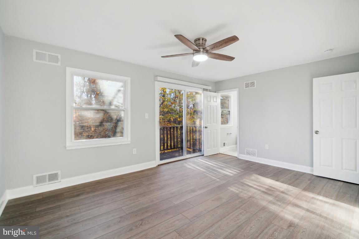 517 Holly Road Fort Washington, MD 20744 - Photo 20 of 40 a view of an empty room with a window and wooden floor