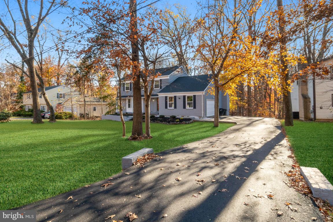 517 Holly Road Fort Washington, MD 20744 - Photo 2 of 40 a front view of a house with a garden and trees