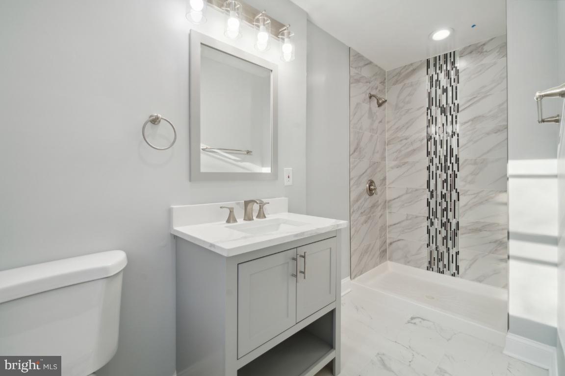 517 Holly Road Fort Washington, MD 20744 - Photo 22 of 40 a bathroom with a sink a toilet and shower