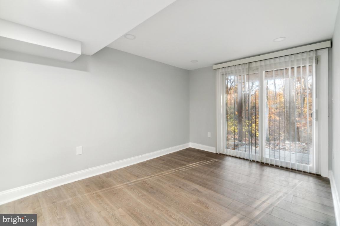 517 Holly Road Fort Washington, MD 20744 - Photo 29 of 40 a view of an empty room with wooden floor and a window