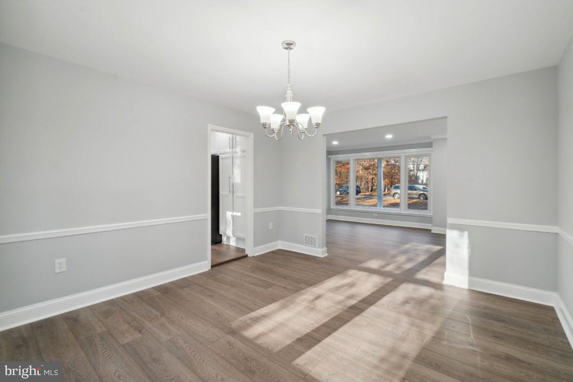 517 Holly Road Fort Washington, MD 20744 - Photo 32 of 40 an empty room with wooden floor and hallway