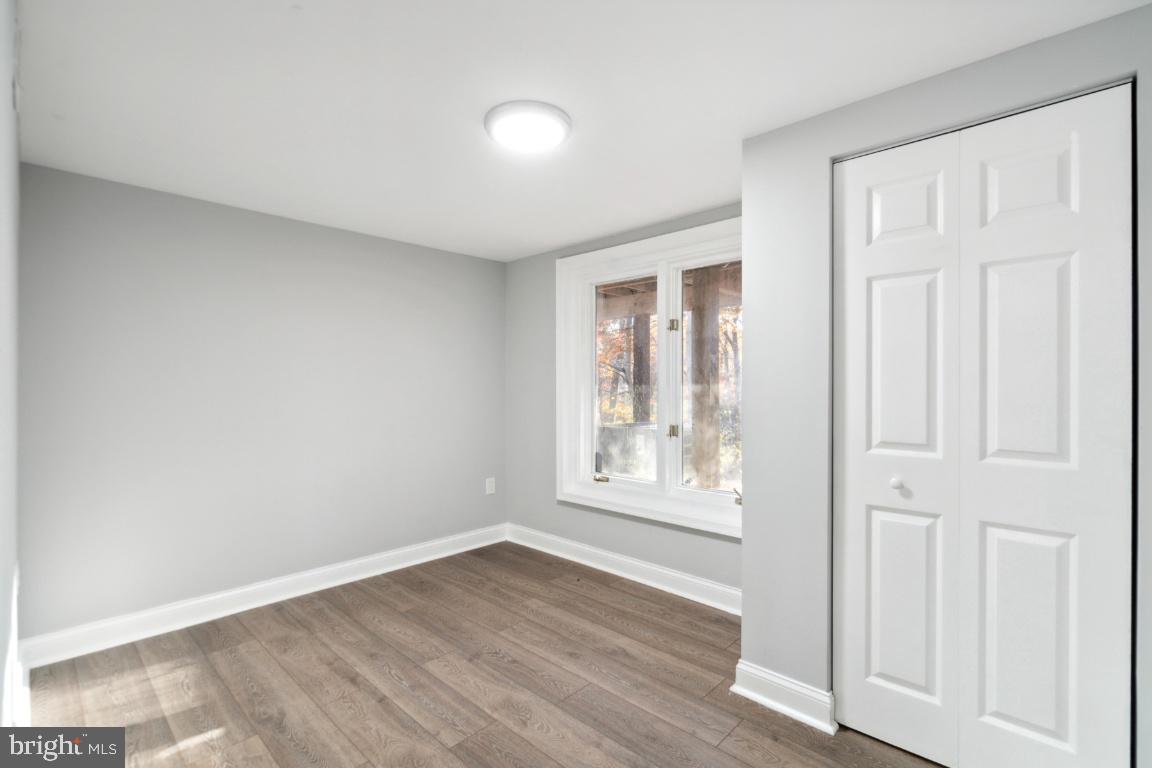 517 Holly Road Fort Washington, MD 20744 - Photo 7 of 40 an empty room with wooden floor and windows