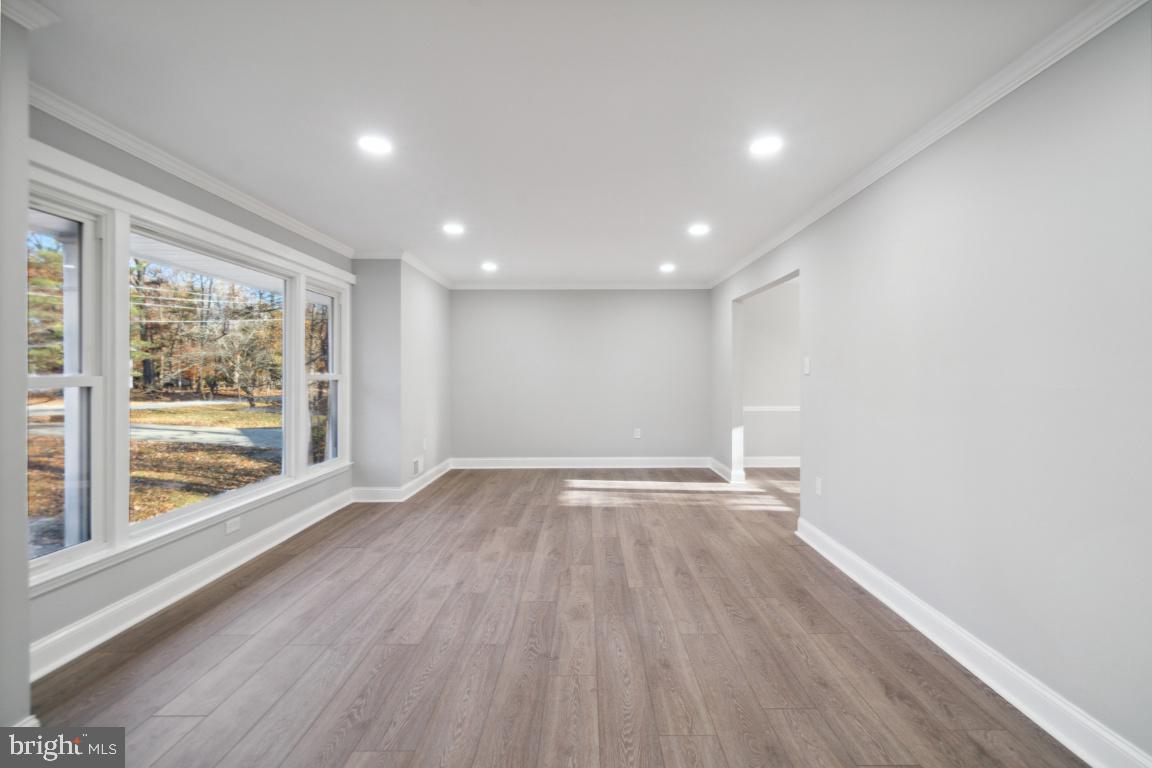 517 Holly Road Fort Washington, MD 20744 - Photo 9 of 40 wooden floor in an empty room with a window