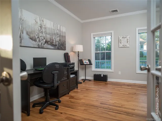 a view of a workspace with furniture and a window