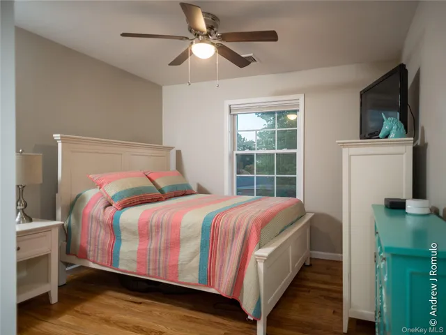 a room with a bed and wooden floor