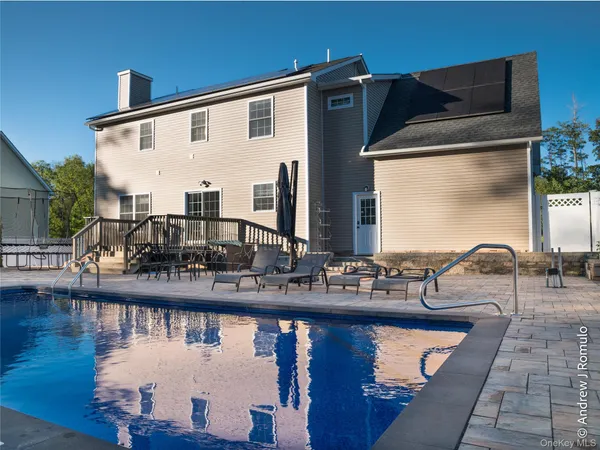 a front view of house with yard outdoor seating and lake view