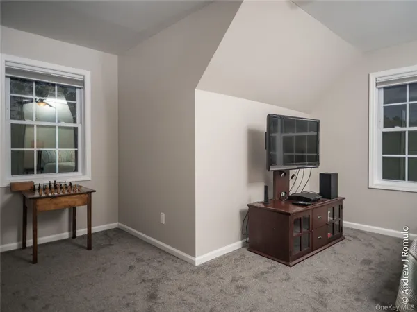 a view of a hallway with wooden floor and stairs