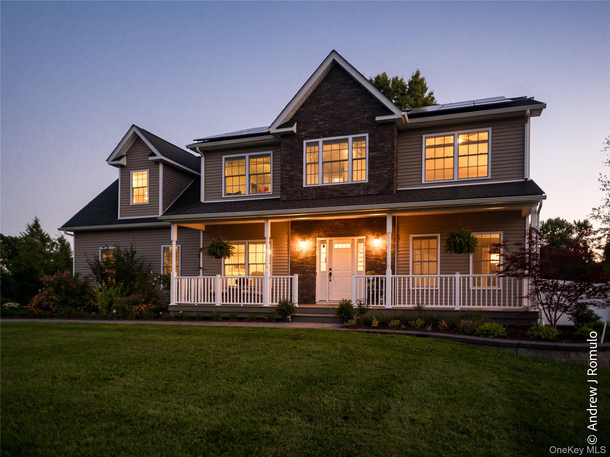 14 Robalene Drive Goshen, NY 10924 - Photo 37 of 39 View of front of property with covered porch, a lawn, stone siding, and roof mounted solar panels