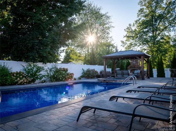a backyard of a house with table and chairs
