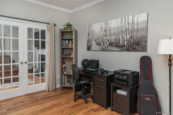 a view of workspace with wooden floor windows wardrobe