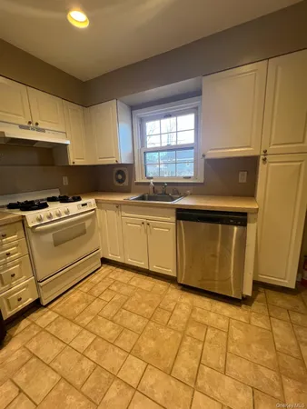 a kitchen with stainless steel appliances granite countertop a sink and cabinets
