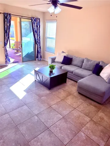 a living room with furniture and a large window