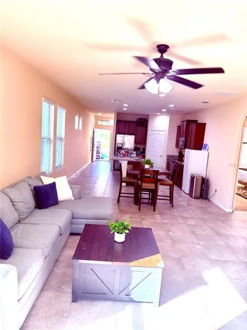 a living room with furniture and kitchen view