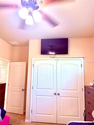 a bathroom with a granite countertop toilet and a sink
