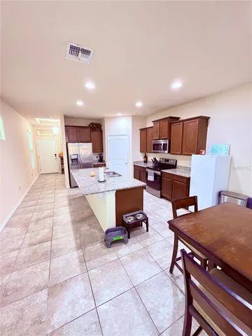 a living room with furniture and kitchen view