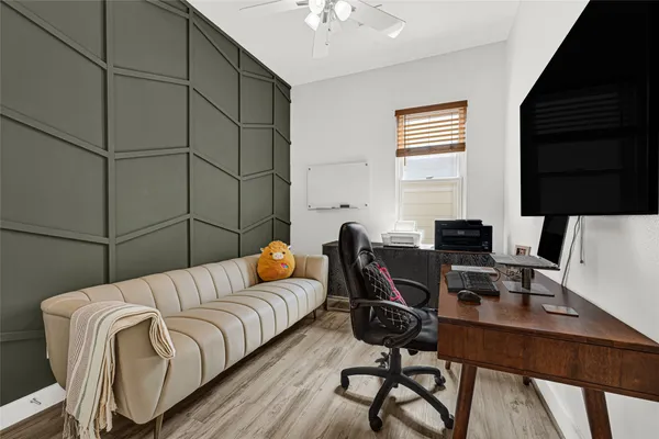 a bedroom with a bed and a desk