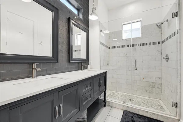 a bathroom with a sink double vanity and a mirror