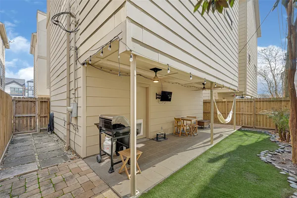 a backyard of a house with table and chairs