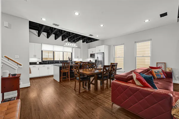 a living room with lots of furniture and kitchen view