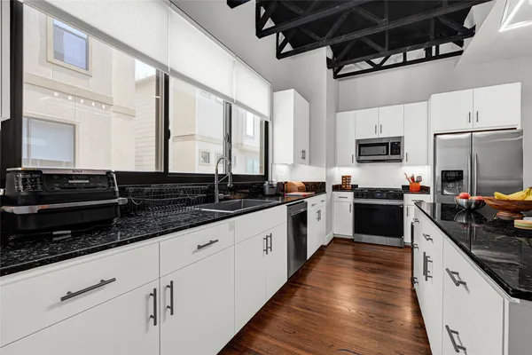 a kitchen with stainless steel appliances a sink stove and refrigerator