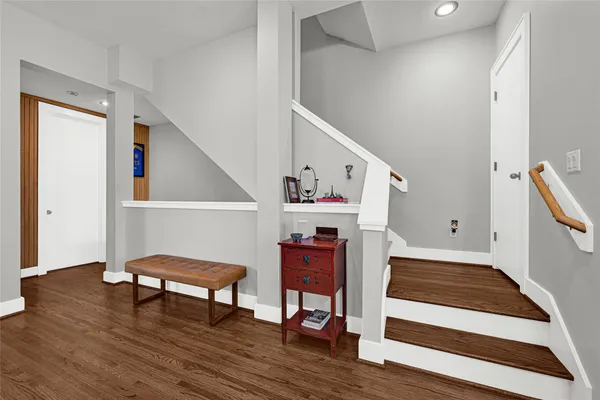 a hallway with wooden floor and furniture