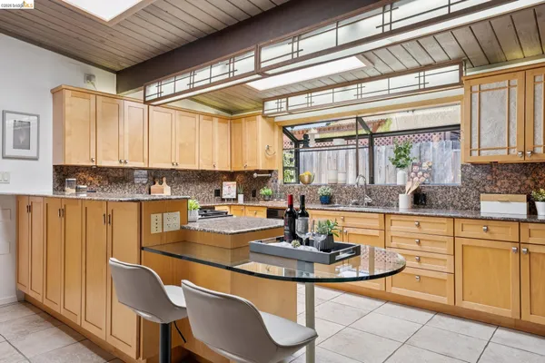 a view of a patio with couches table and chairs and potted plants