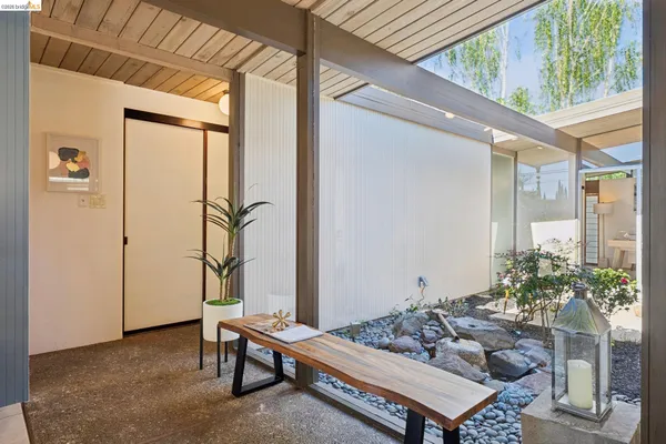 a view of a swimming pool with a patio and wooden fence