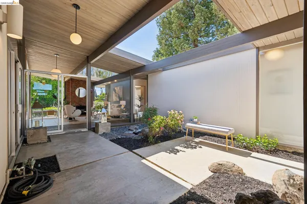 a living room with furniture a fireplace and a large window