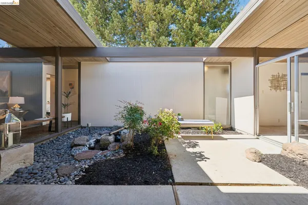 a living room with fireplace furniture and a large window
