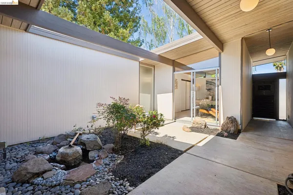 a living room with patio furniture and a fireplace