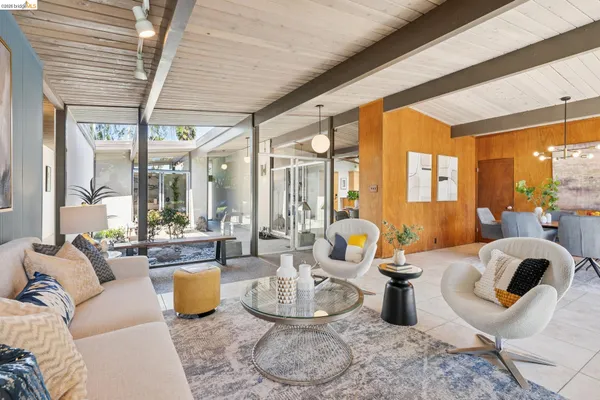 a dining hall with stainless steel appliances a stove a table and chairs