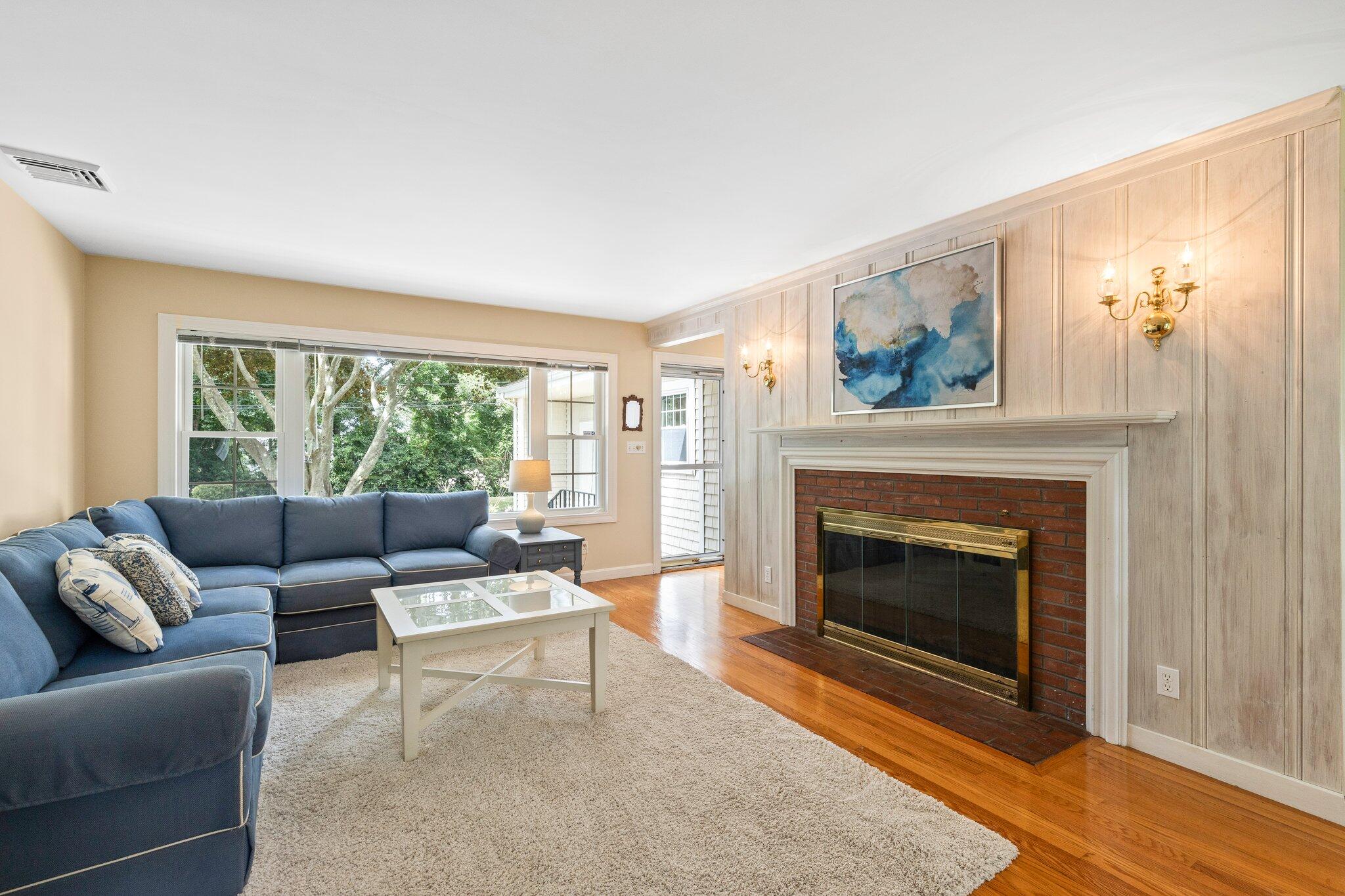 87 Conners Road Centerville, MA 02632 - Photo 11 of 54 a living room with furniture and a fireplace