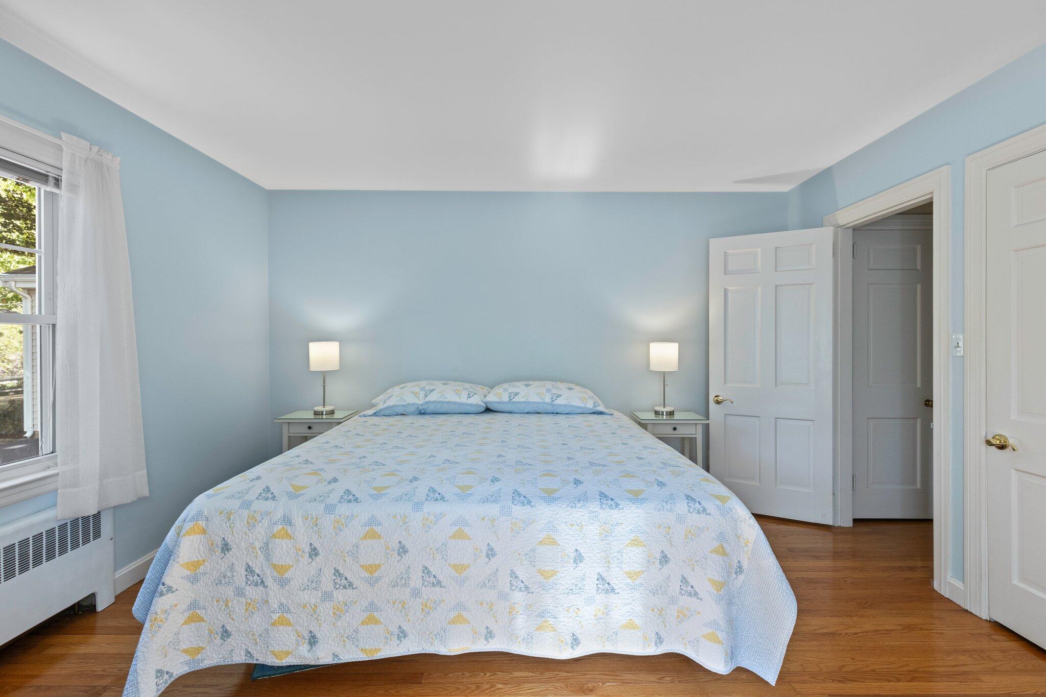 87 Conners Road Centerville, MA 02632 - Photo 30 of 54 a bedroom with a bed and wooden floor