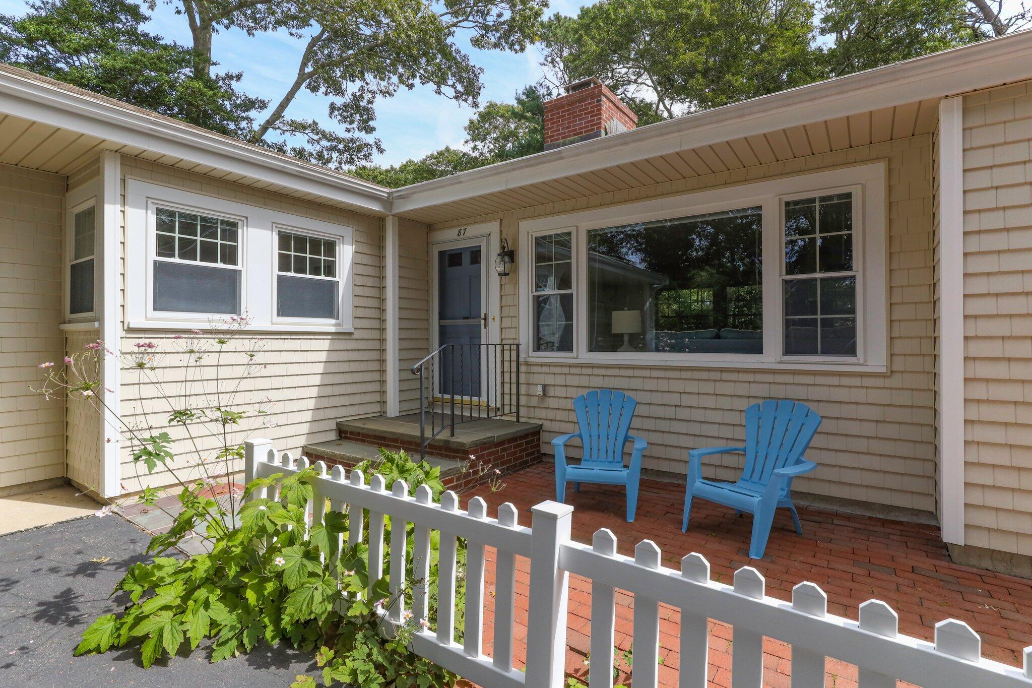 87 Conners Road Centerville, MA 02632 - Photo 7 of 54 a front view of a house with outdoor seating
