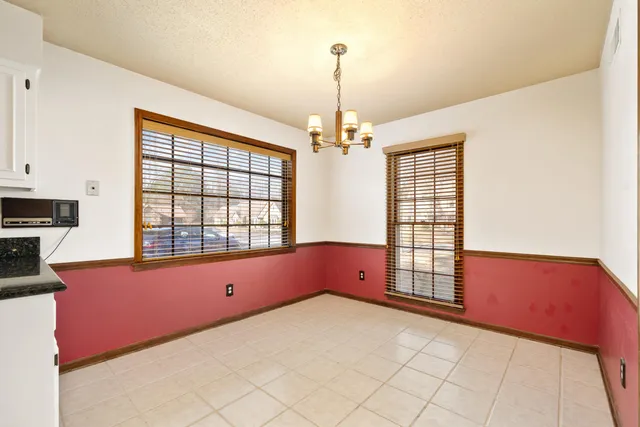 a spacious bedroom with a bed and a window