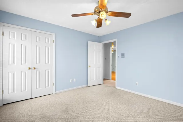 an empty room with chandelier fan