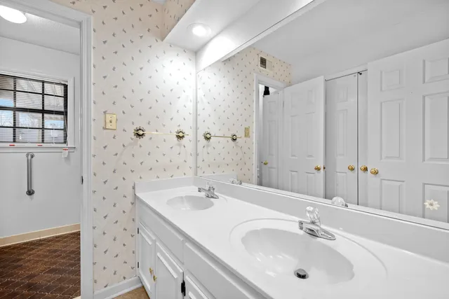 a bathroom with a sink a mirror and a shower