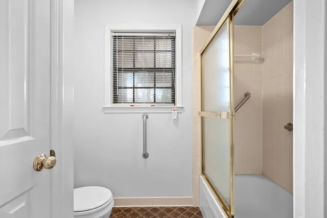 a bathroom with a toilet and shower