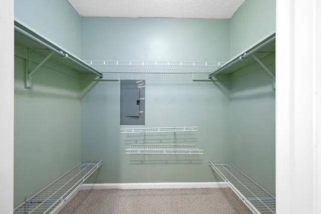 a view of walk in closet with empty racks