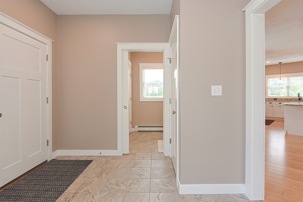 128 Nourse Road Bolton, MA 01740 - Photo 13 of 42 a view of a hallway with wooden floor and a living room