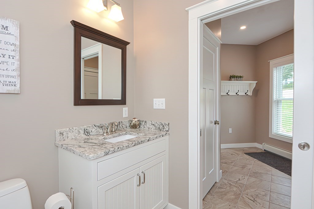 128 Nourse Road Bolton, MA 01740 - Photo 15 of 42 a bathroom with a sink a vanity and a mirror